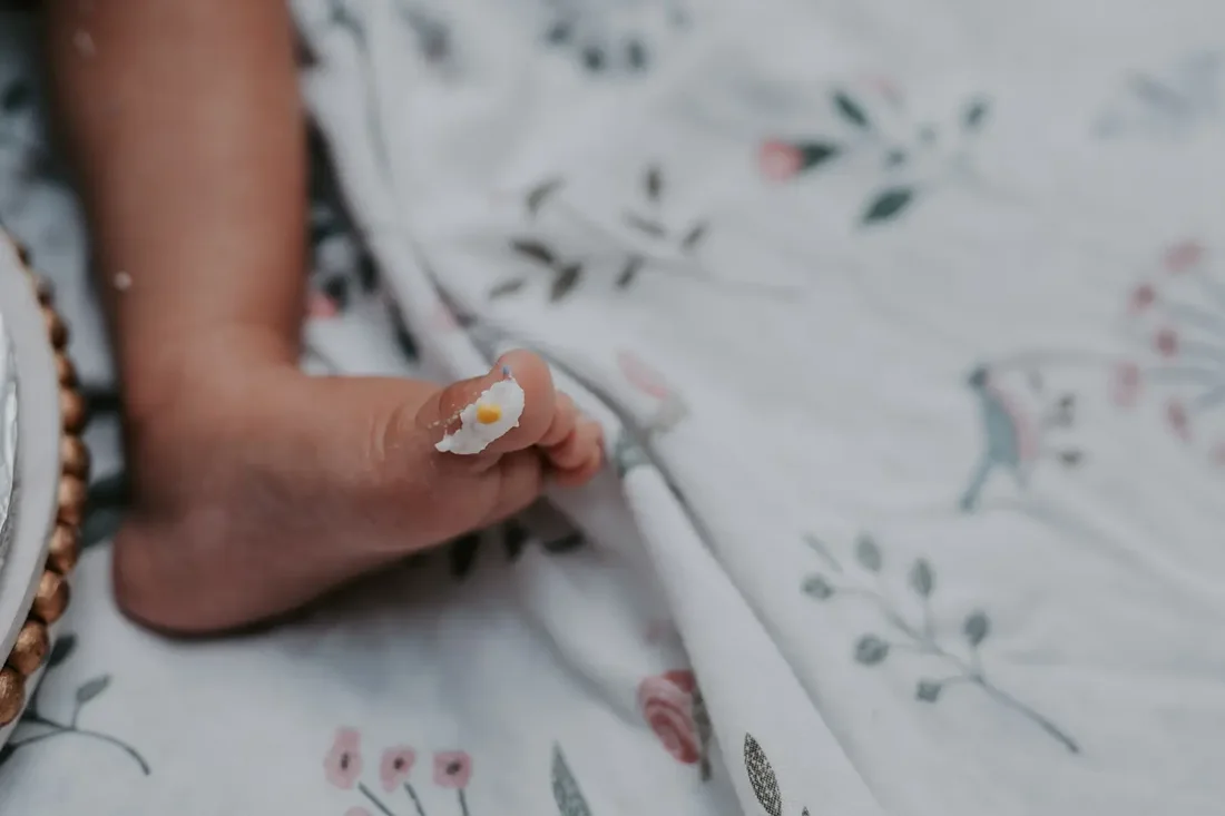 Baby's foot with cake frosting, detail shot