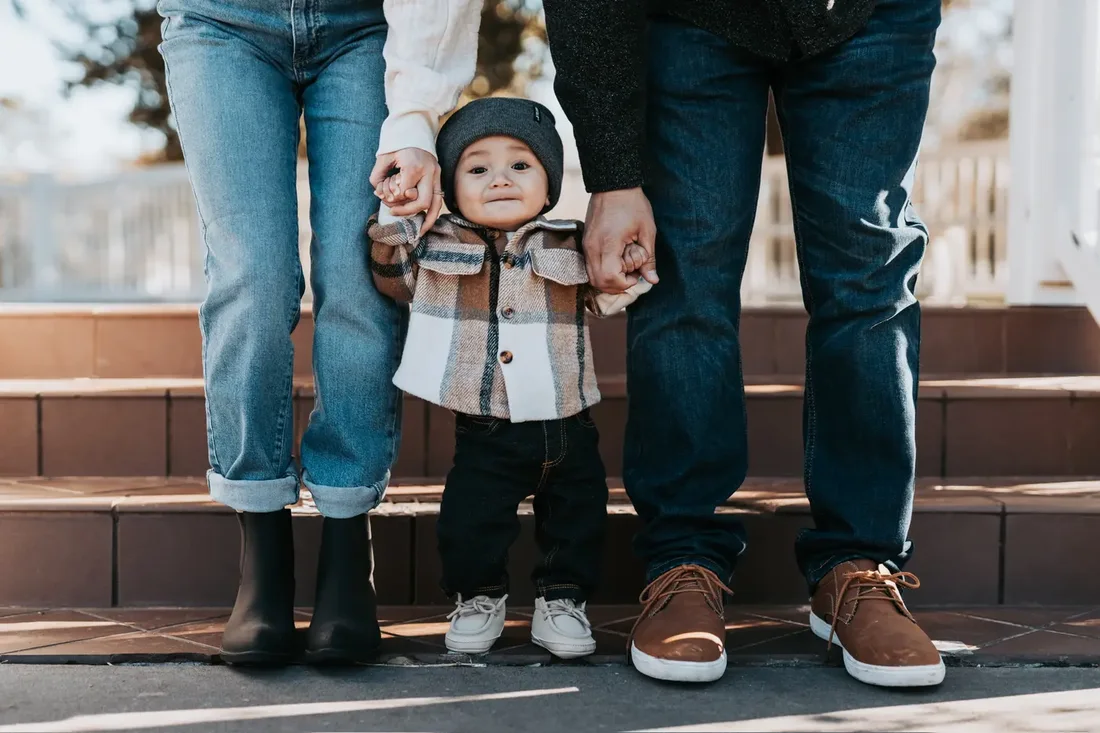 Family walking together, close-up on shoes and hands