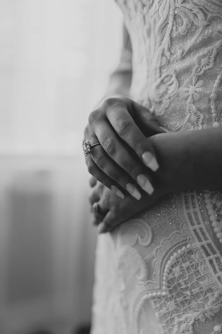 Bride's hands resting together, detail shot, black and white