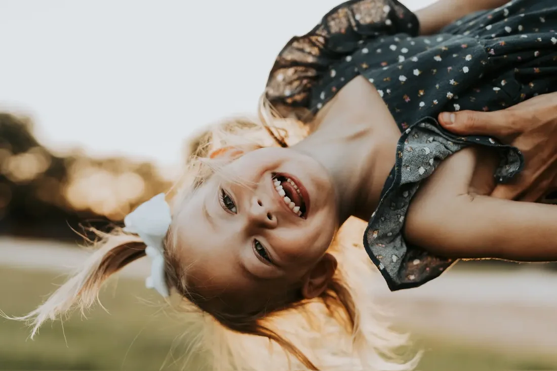 Toddler laughing upside down