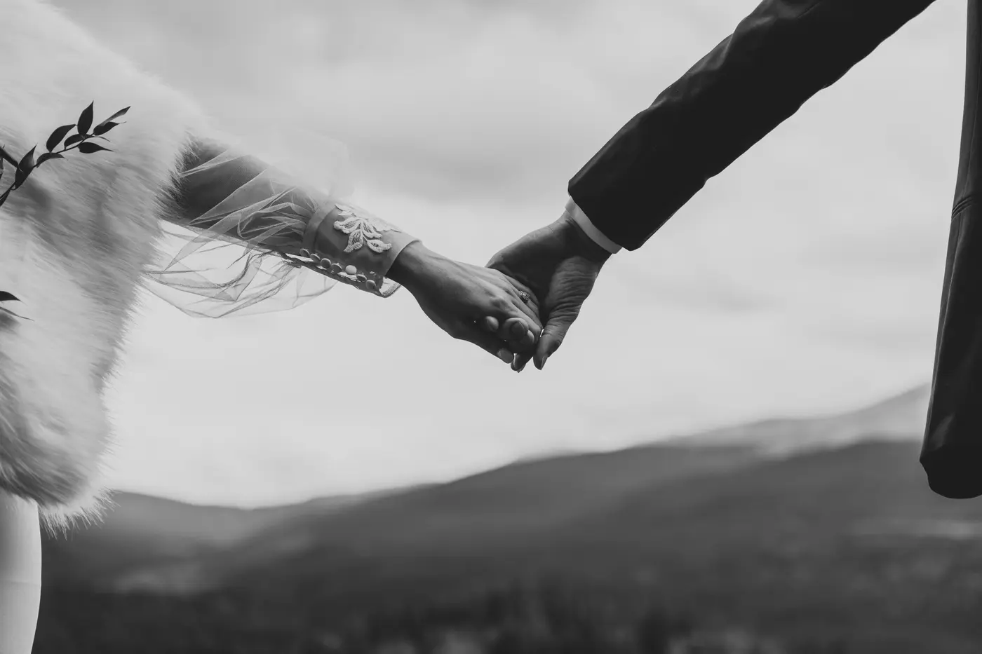 Bride and groom holding hands, mountain elopement, black and white