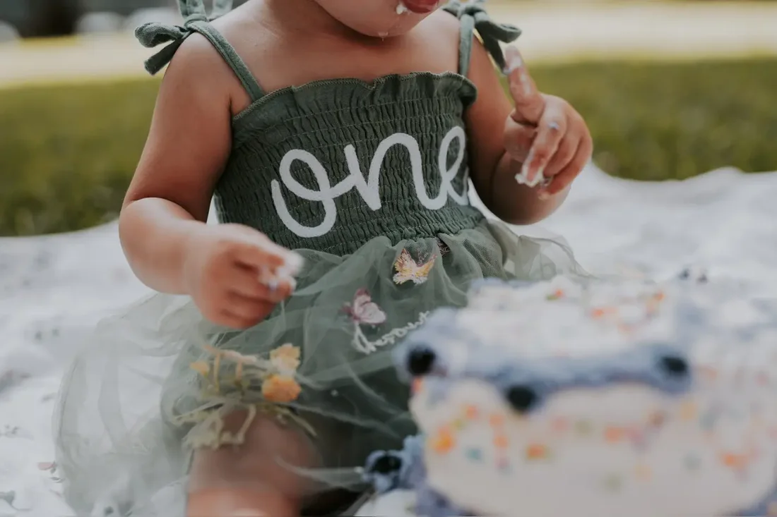Toddler in a tulle 'one' outfit at a birthday cake smash