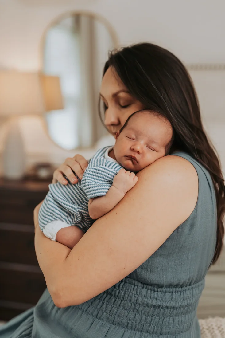 Mother holding her sleeping newborn