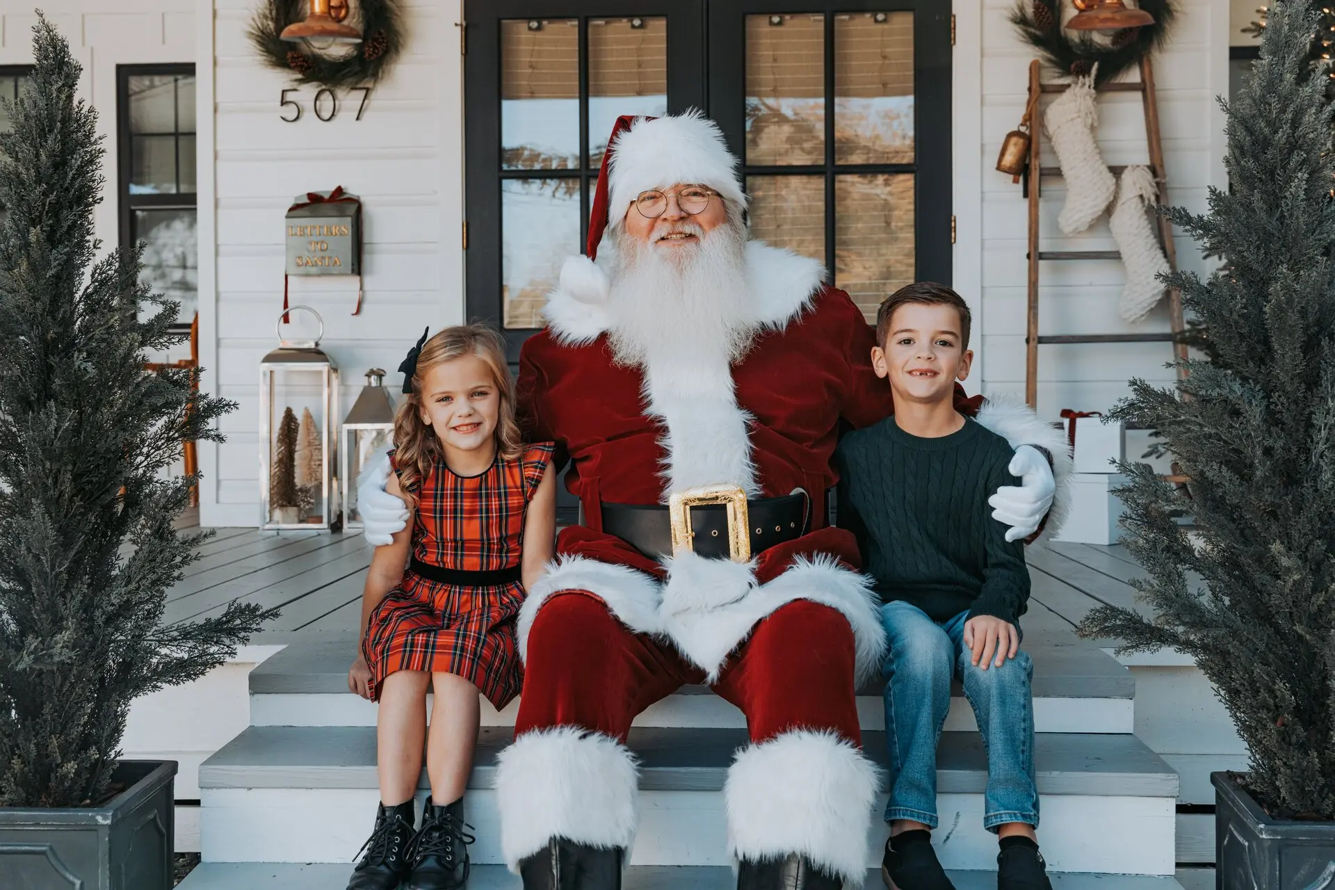 Family visiting with Santa on a decorated porch