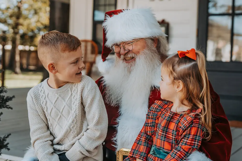 Family taking a photo with Santa at a past Santa Minis session
