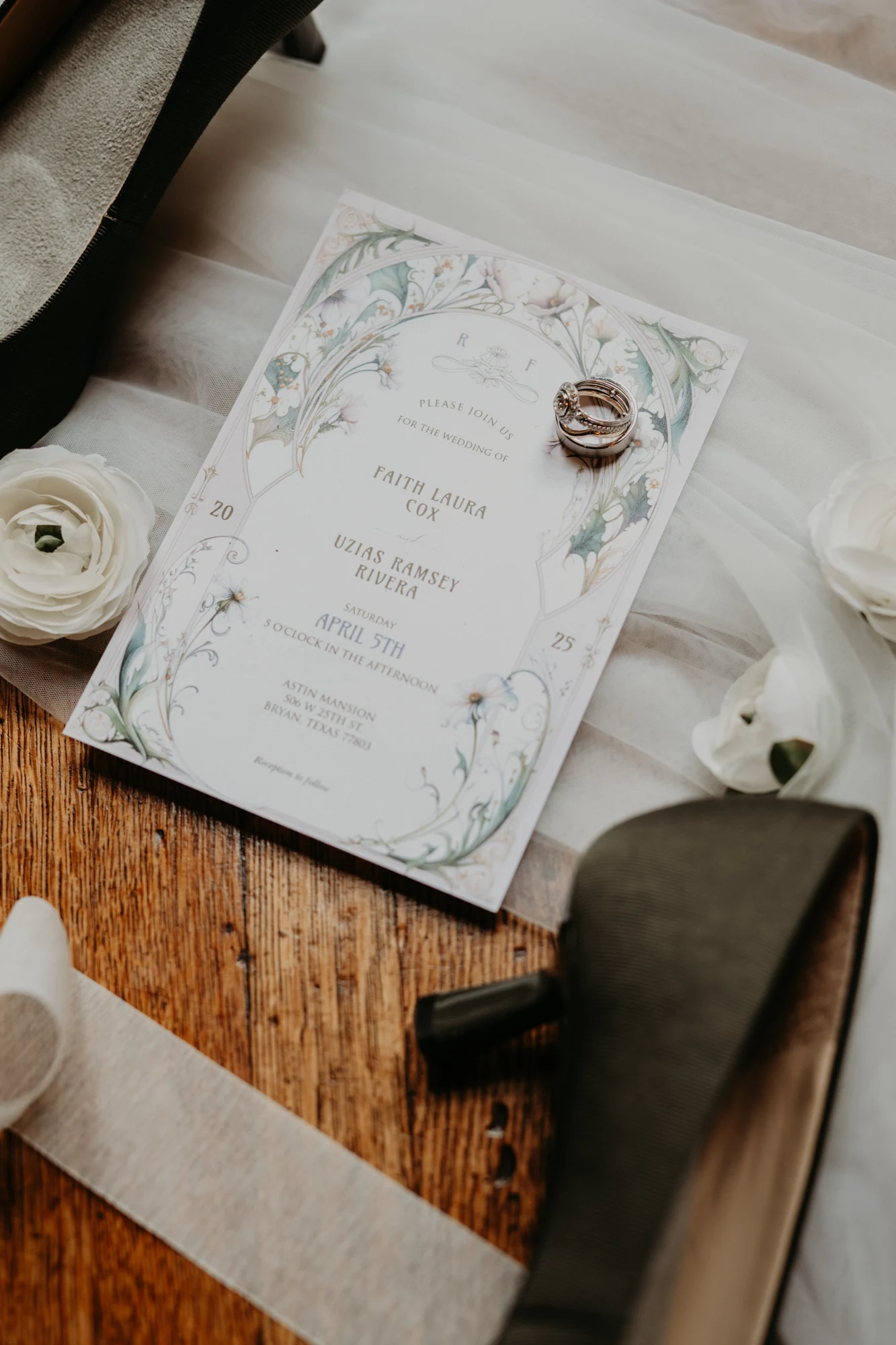 Wedding invitation with rings and shoes, detail shot