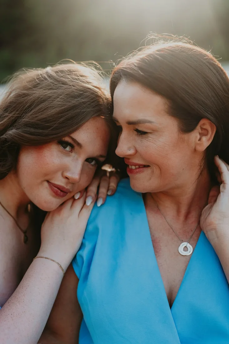 Mother and daughter sharing a laugh at golden hour